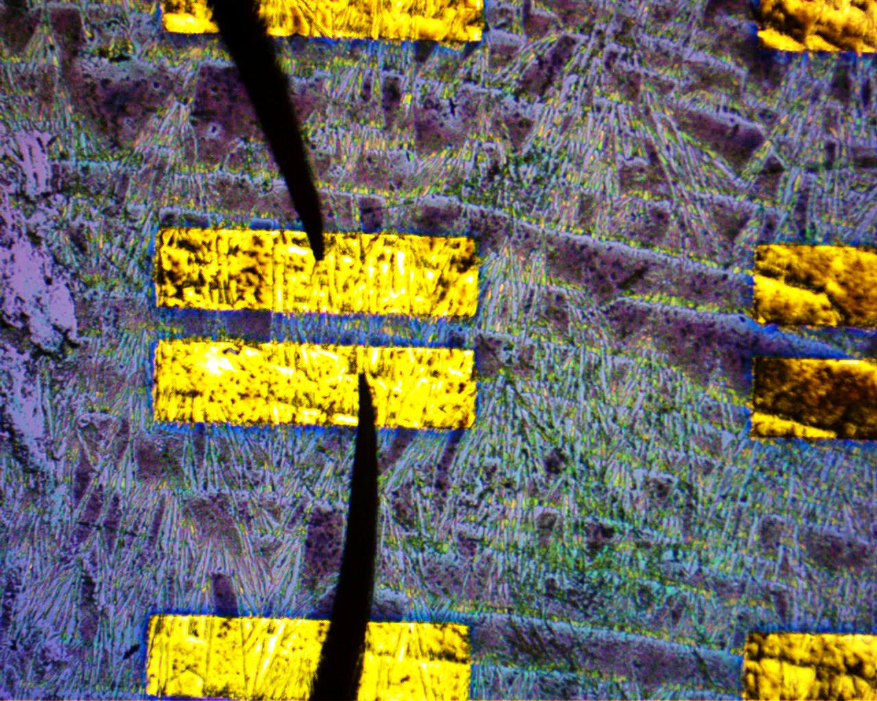 Probe Station pins interacting with the Au electrodes on the Silicon Wafer sample